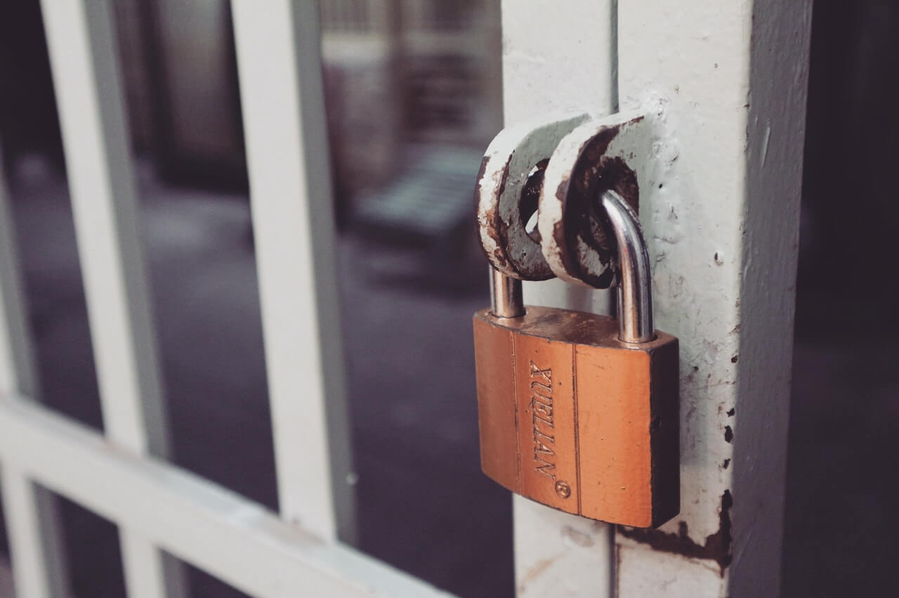 Online security is to your digital finances as this padlock is to the white gate it protects