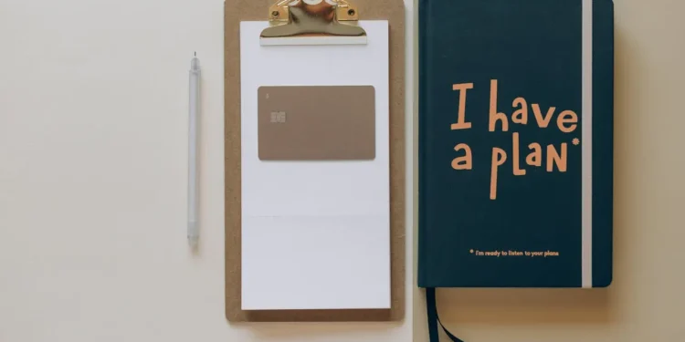 A clipboard and a journal that says I have a plan.