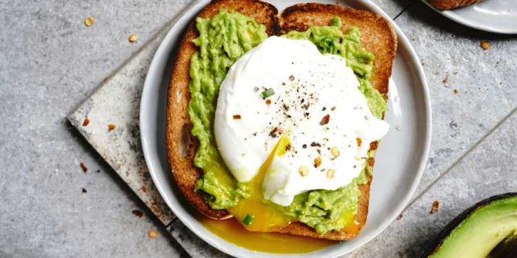 A plate of Avocado Toast with a poached egg for a Budget Brunch Spread.