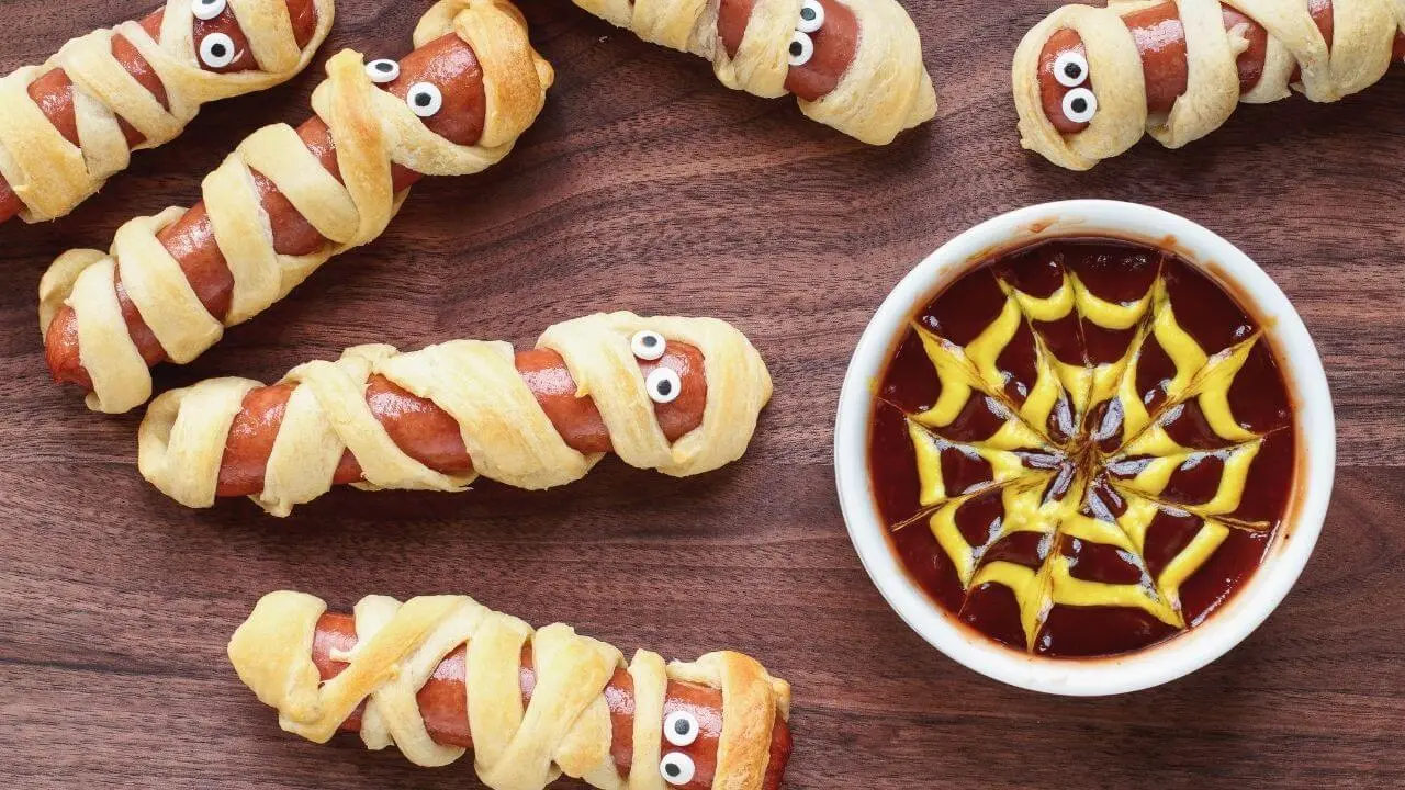 Don't drop a bundle on your Halloween recipes, like these Mummy Hot Dogs.