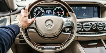 A view from the driver's seat of a luxury Mercedes steering wheel. Adopting a rich mindset can make all the difference in your savings plans.