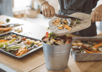 A woman prepares food in the kitchen. Clean out your freezer with these recipes.