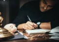 a man writing in a book