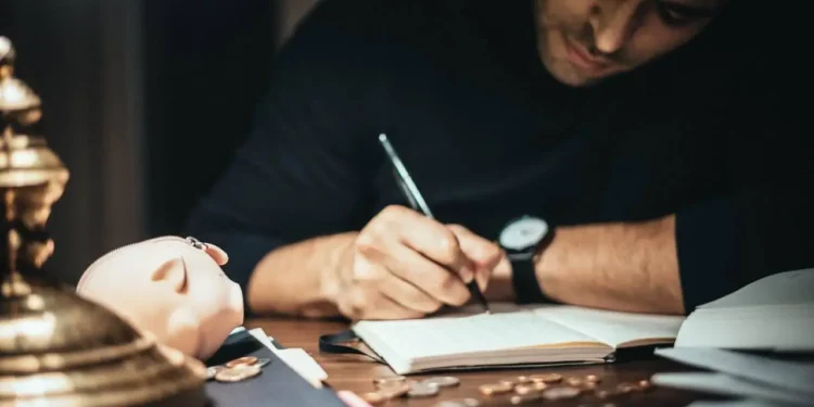 a man writing in a book