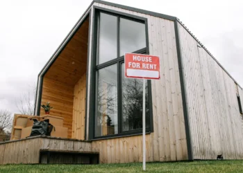 A low level shot of a wooden house. Rental properties can be lucrative if you know what you're looking for.