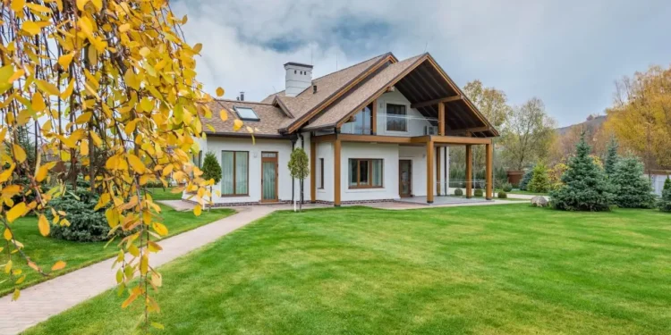 A beautiful Ranch-style house on a sprawling green lawn. Is buying a home a good investment?
