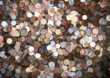 A huge pile of silver and bronze coins. Extreme cheapskates are major penny pinchers.