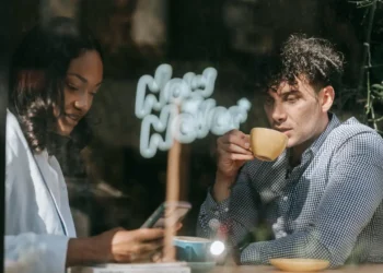 A man and woman sit in a cafe drinking coffee beside the window. Maximize your savings by prioritizing what you really love.