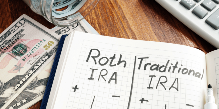 Open notebook on a desk turned to a page that reads: Roth IRA and Traditional IRA.