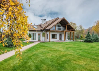 Beautiful big house on a green lawn. Can you use financial leverage to make real estate investments?