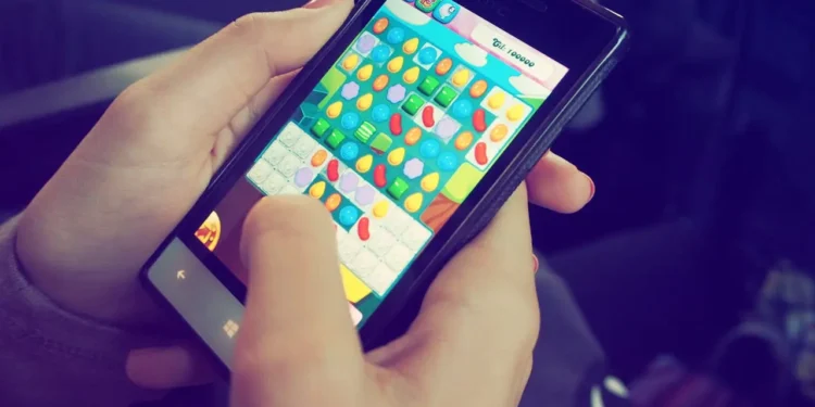 Person plays games on a phone. Gaming and gambling marketing wants you to spend.