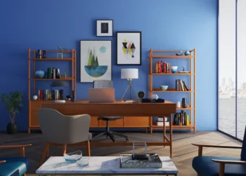 Home office with bright blue walls and cedar furniture.