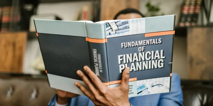Man reading a financial literacy book.