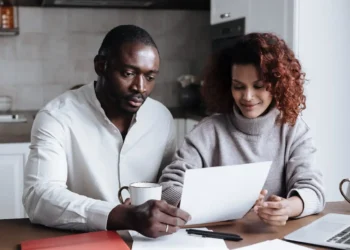 Couple looks at the rising costs of their bills together.