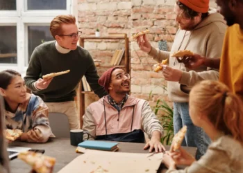 A group of friends eat pizza around a table. What does your dream life look like?