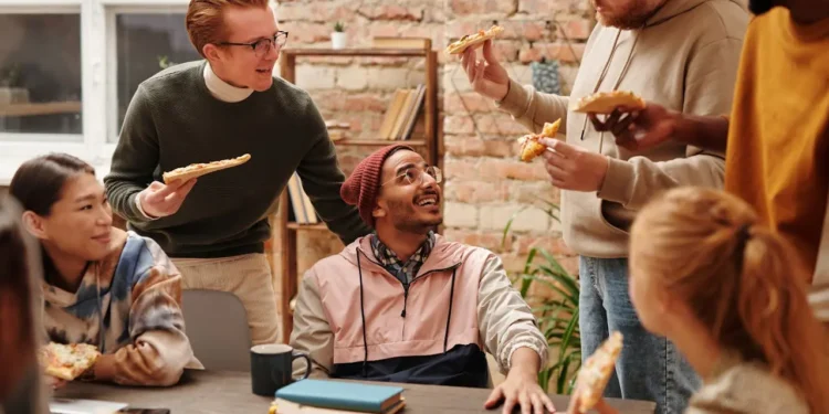 A group of friends eat pizza around a table. What does your dream life look like?