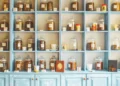 An organized blue wall of shelves full of labeled glass jars. The pantry is one of the key areas to organize.