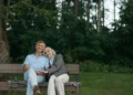 A retired couple rests on a bench together. What's the true cost of retirement?