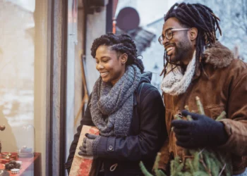 Couple shopping holiday sales outside.