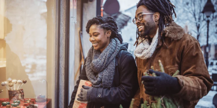 Couple shopping holiday sales outside.