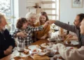 Family gathers around a table after holiday travel.
