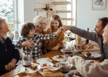 Family gathers around a table after holiday travel.